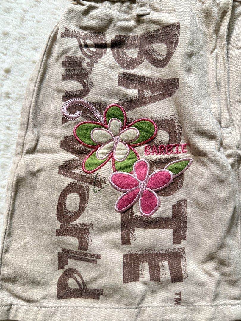 Barbie Cargo Skirt kids (Category: Skirts) located in Tagaytay City. Submitted by melissamm0237 (Listing ID 1464400638, Image 2). Description: - Cute tan cargo skirt from Barbie World. - Features embroidered flowers and 'Barbie World' text. - Convenient pocket on the right side. - Comfortable elastic waistband at the back. - Ideal for casual wear. - Tag size: 10 years..