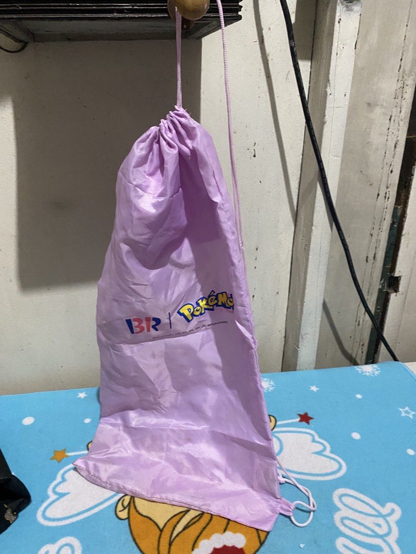 Baskin Robbins x Pokemon Promotional Drawstring Bag (Category: Backpacks) located in Manila. Submitted by resi.diaz (Listing ID 1464511015, Image 3). Description: - Light purple drawstring bag - Bag only. NO badminton rackets inside. - Features Baskin Robbins and Pokemon logos - Includes a small inner pocket - Ideal for carrying small items - Makes a great gift for Pokemon fans - Easy drawstring closure.