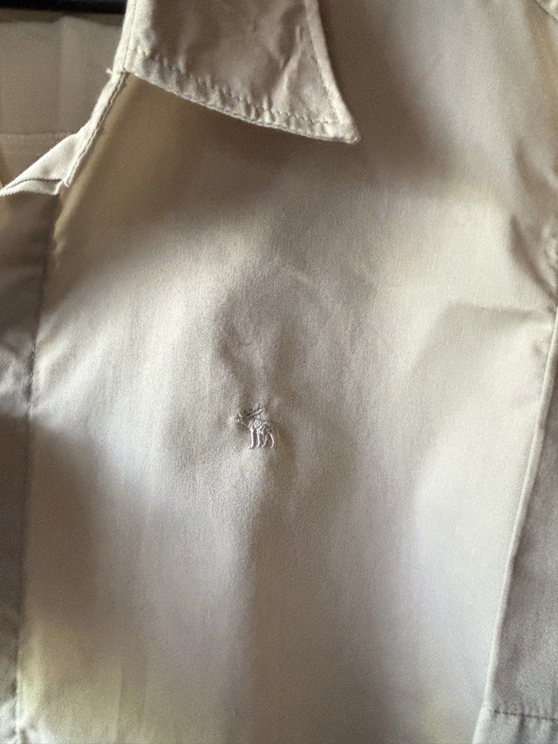Beige Button-up Shirt (Category: Formal Shirts) located in Vigan. Submitted by prelovedbyr.1 (Listing ID 1464365823, Image 2). Description: personal preloved item color may vary due to lighting fits s-m condition: 10/10 loc: vigan city, I.S. mop: gcash/maribank mod: J&T.