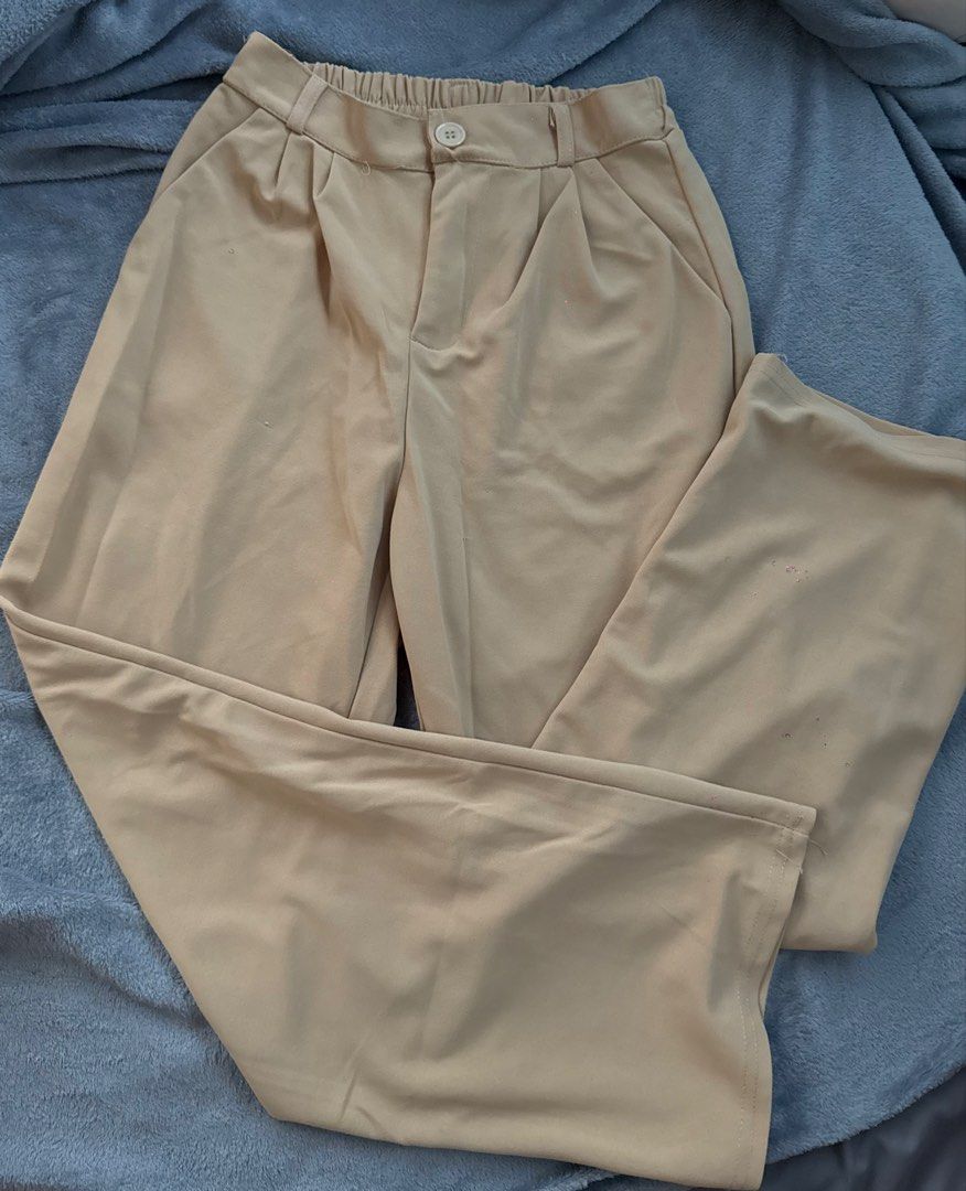 Beige High-Waisted Wide Leg Pants (Category: Jeans) located in Manila. Submitted by razshen_29 (Listing ID 1464486861, Image 1). Description: Waist: 22.4 inches (still stretchable) Length: 37 inches - Beige high-waisted pants - Wide leg silhouette - Comfortable elastic waistband at the back - Two functional front pockets - Minor loose stitches on the bottom - Perfect for casual and dressier occasions.