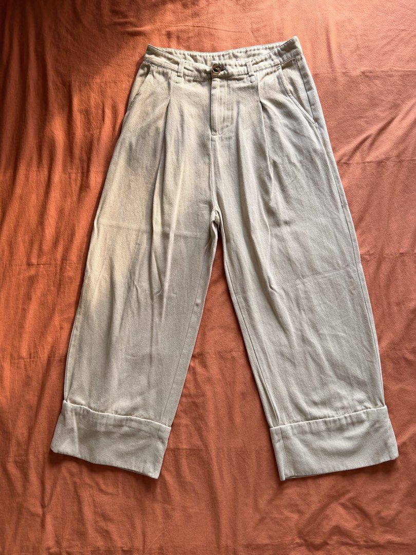 Beige Wide Leg Cropped Pants (Category: Other Bottoms) located in Manila. Submitted by pvreal (Listing ID 1464444648, Image 1). Description: - Beige wide leg pants - Cropped length with cuffed hem detail (no actual fold) - Pleated front detail - High waisted fit - Two side pockets - Button and zip closure - Ideal for casual wear.