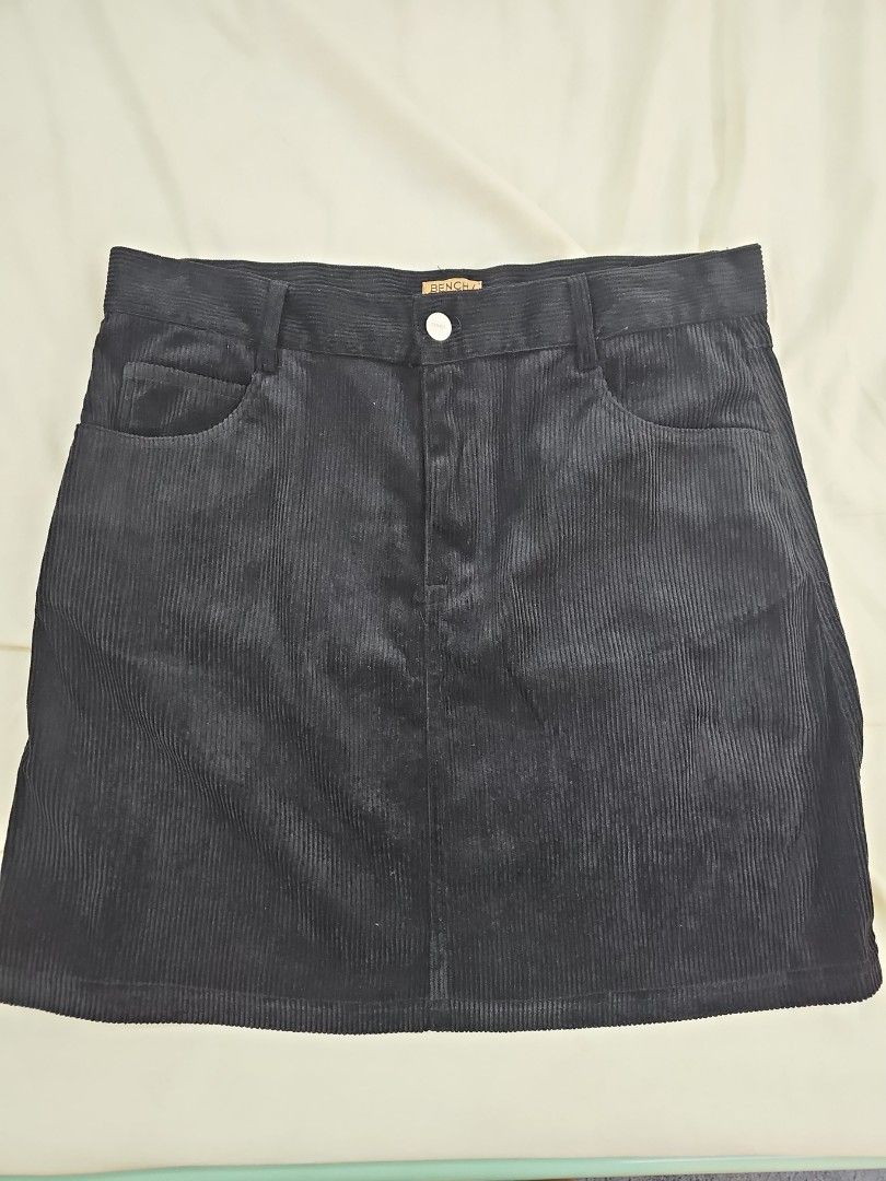 Bench Black Corduroy Mini Skirt (Category: Skirts) located in Muntinlupa City. Submitted by shoptitak (Listing ID 1464460282, Image 1). Description: - Black corduroy mini skirt - Four pockets - Textured fabric - Button and zip front closure - Versatile and easy to style.