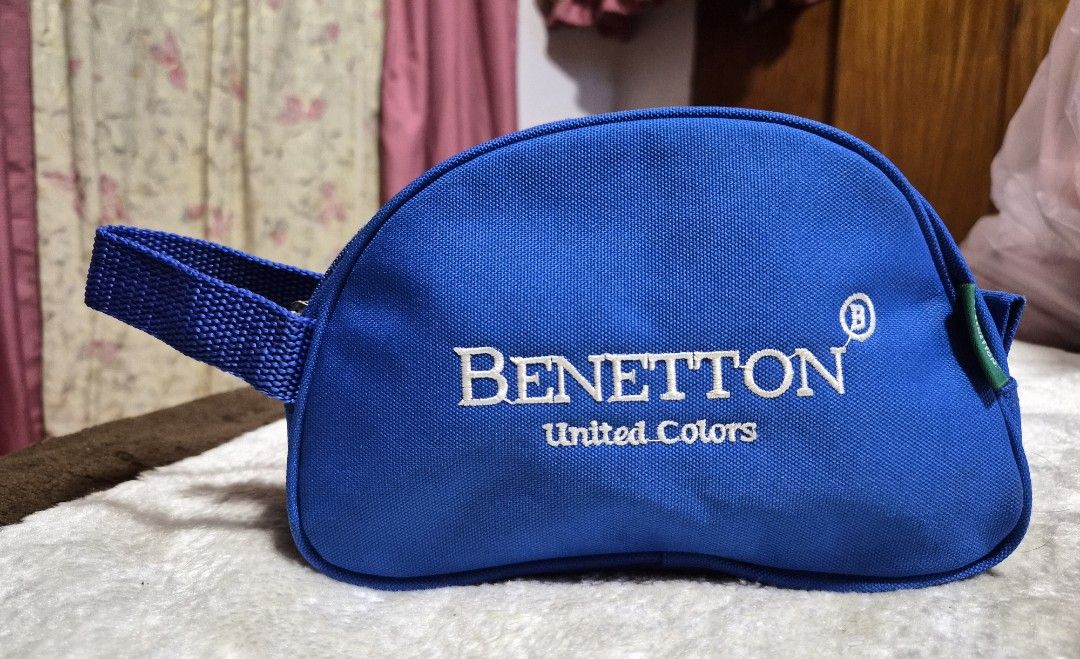 Benetton United Colors Blue Pouch (Category: Purses & Pouches) located in Mandaue City. Submitted by chuchi152615 (Listing ID 1464405067, Image 1). Description: - Blue Benetton pouch - Zipper closure - Convenient side handle - Internal small pocket for organization - Ideal for keeping small items tidy - Approximate dimensions: 8 inches long, 4 inches tall.