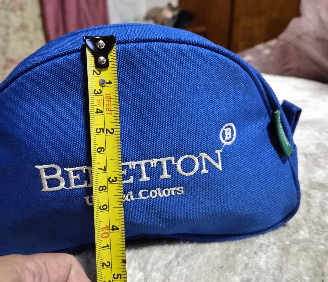 Benetton United Colors Blue Pouch (Category: Purses & Pouches) located in Mandaue City. Submitted by chuchi152615 (Listing ID 1464405067, Image 3). Description: - Blue Benetton pouch - Zipper closure - Convenient side handle - Internal small pocket for organization - Ideal for keeping small items tidy - Approximate dimensions: 8 inches long, 4 inches tall.