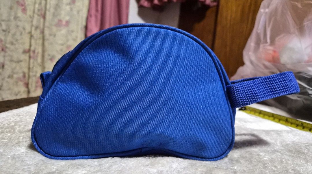 Benetton United Colors Blue Pouch (Category: Purses & Pouches) located in Mandaue City. Submitted by chuchi152615 (Listing ID 1464405067, Image 2). Description: - Blue Benetton pouch - Zipper closure - Convenient side handle - Internal small pocket for organization - Ideal for keeping small items tidy - Approximate dimensions: 8 inches long, 4 inches tall.
