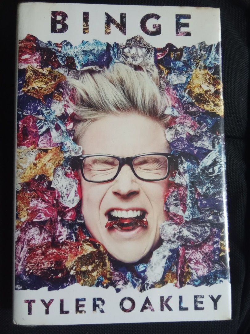 Binge by Tyler Oakley (Category: Storybooks) located in Pasig City. Submitted by teebeedeee (Listing ID 1464396586, Image 1). Description: - Binge by Tyler Oakley - hardcover edition - Collection of essays and personal stories - Features vibrant and eye-catching cover art - Pages are clean and well-maintained - Spine is intact - Ideal for fans of Tyler Oakley preowned hardcover book complete pages plastic covered.no visible penmarks for meetups i