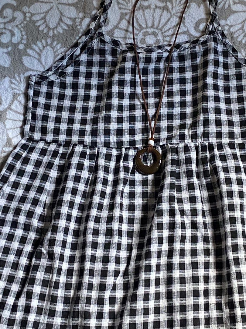 Black and White Gingham Sundress (Category: Dresses) located in Manila. Submitted by mysticcat15 (Listing ID 1464473732, Image 2). Description: - Adorable black and white gingham sundress - Features delicate spaghetti straps - Flirty ruffled hemline - Comes with a simple brown pendant necklace - Ideal for casual outings, beach days, or picnics - Effortless to wear and style.