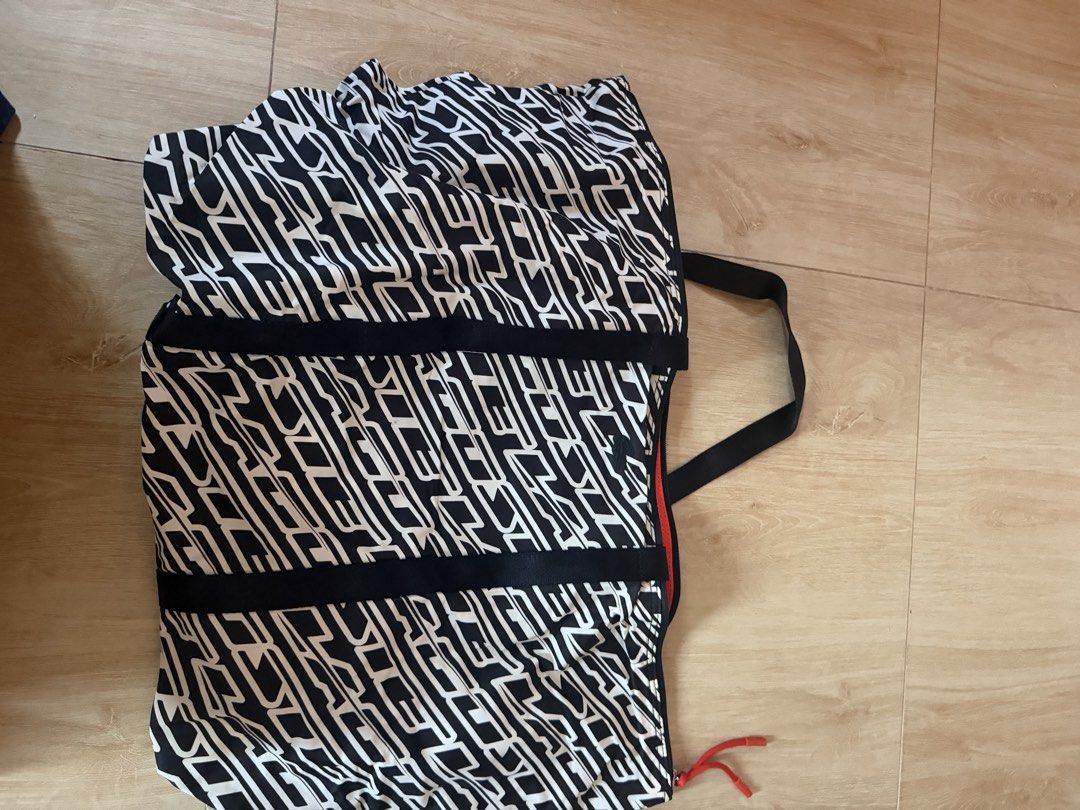 Black and White Pattern Tote Bag with Black Straps (Category: Tote Bags) located in Santa Rosa. Submitted by decluttering_. (Listing ID 1464363112, Image 2). Description: - Stylish black and white abstract pattern - Durable black straps - Vibrant red interior trim - Matching patterned lining - Ample interior space for essentials - Secure zip-top closure - Ideal for everyday use or travel.