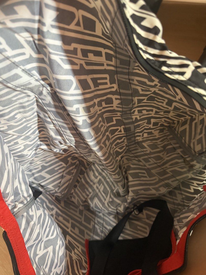 Black and White Pattern Tote Bag with Black Straps (Category: Tote Bags) located in Santa Rosa. Submitted by decluttering_. (Listing ID 1464363112, Image 3). Description: - Stylish black and white abstract pattern - Durable black straps - Vibrant red interior trim - Matching patterned lining - Ample interior space for essentials - Secure zip-top closure - Ideal for everyday use or travel.