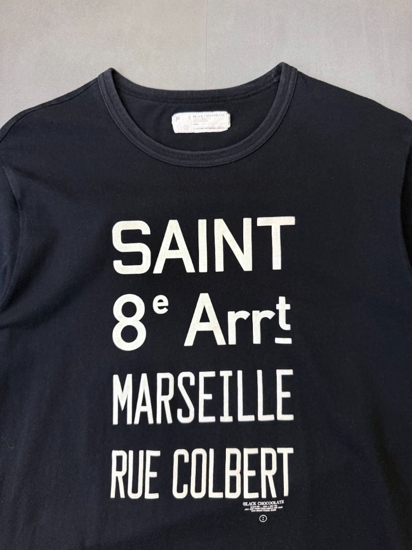 Black Chocoolate Saint tee shirt (Category: Tshirts & Polo Shirts ) located in Cabanatuan. Submitted by argarments.ph (Listing ID 1464480204, Image 2). Description: Tagged: XL on tag, fits large Width 21" | Length 29.5" Condition: Great condition Issue(s): -.