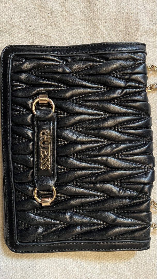 Black Guess Quilted Chain Shoulder Bag (Category: Shoulder Bags) located in Cagayan de Oro. Submitted by nelsondel21723 (Listing ID 1464386189, Image 2). Description: - Black Guess shoulder bag - Gold chain strap - Quilted design on front flap - Interior zip pocket and main compartment - Magnetic snap closure - Gold hardware details - Versatile for nights out or everyday use.