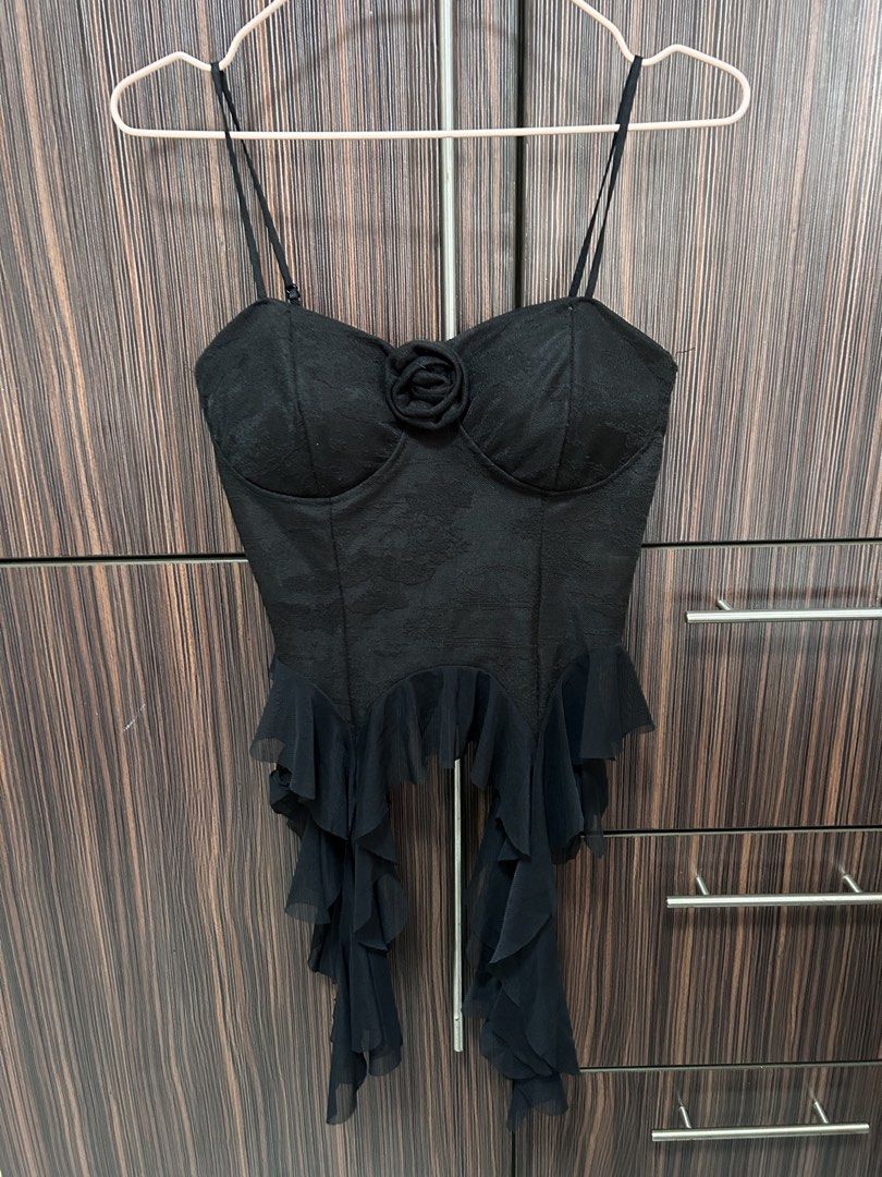 Black Lace Padded Corset Top One Size Stretchable (Category: Sleeveless) located in Cebu City. Submitted by pau.ky (Listing ID 1464481032, Image 2). Description: -RFS: Decluttering - Black lace corset top - Padded cups for support - One size fits most (stretchy material) - Features a delicate rose detail on the bust - Ruffled trim at the hem for a feminine touch - Super versatile: perfect for dressing up or layering - Note: Actual color may vary 