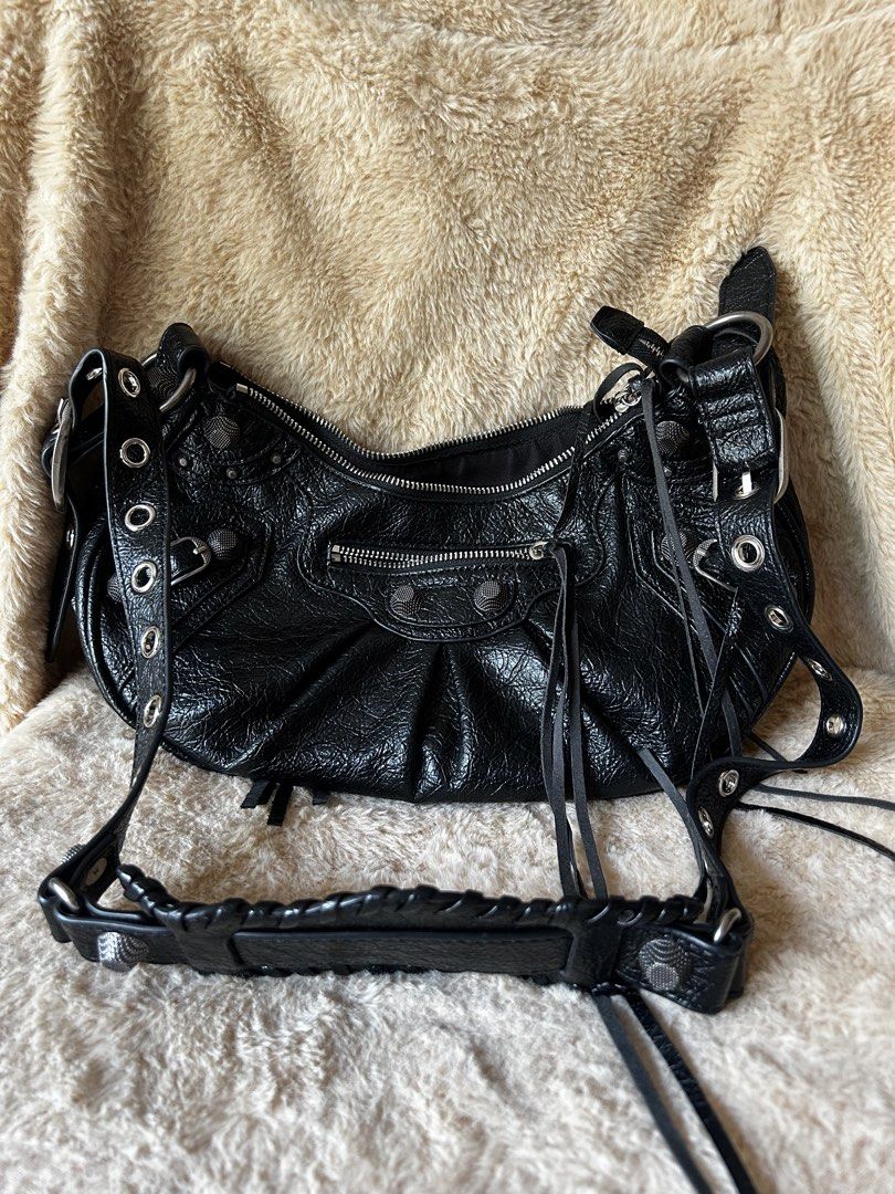 Black Leather Studded Shoulder Bag (Category: Luxury Bags & Wallets) located in Cebu City. Submitted by yenetcuba52435 (Listing ID 1464366412, Image 1). Description: - Stylish black leather shoulder bag - Silver hardware accents - Edgy studs and fringe details - Secure top zip closure - Adjustable strap for comfort - Textured leather finish - Ample space for essentials - Ideal for everyday use.