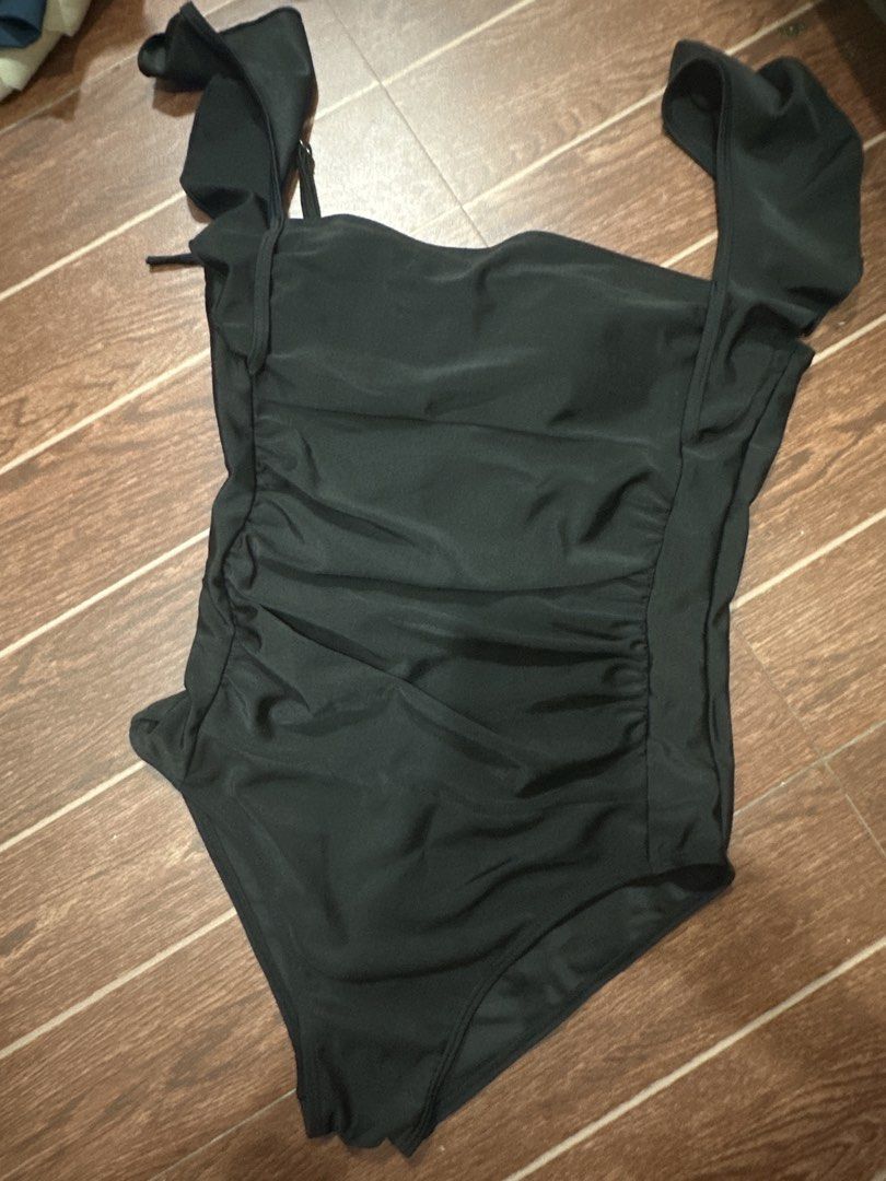 Black Ruffle Strap Ruched One-Piece Swimsuit (Category: Bikinis & Swimsuits) located in Marikina City. Submitted by rctoby00 (Listing ID 1464440861, Image 2). Description: - Chic black one-piece swimsuit - Flattering ruffle straps - Adjustable ruched sides for a perfect fit - Elegant square neckline - Secure and adjustable back ties - Ideal for beach and pool outings - Comfortable and stylish design.