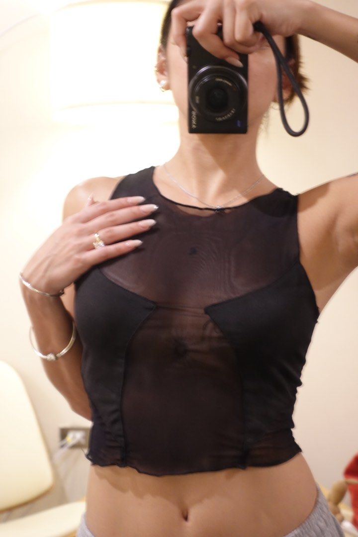Black sheer mesh crop top (Category: Sleeveless) located in Pasig City. Submitted by hulyascloset (Listing ID 1464543842, Image 1). Description: - Black sheer mesh fabric - Sleeveless design - Round neckline - Cropped length (waist-hitting) - Versatile for layering or standalone wear - Pairs well with high-waisted pants/skirts.