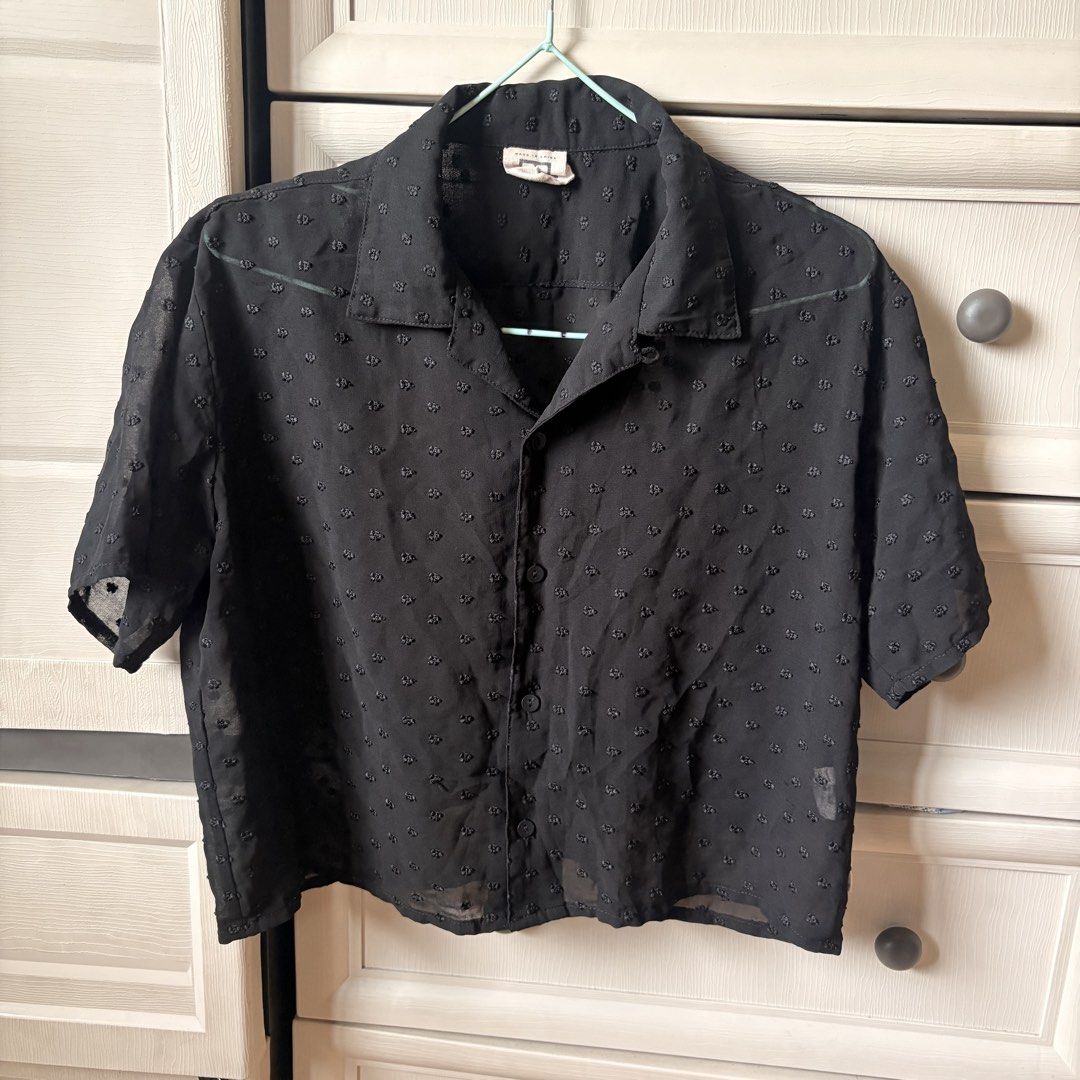 Black Sheer Textured Button-Up Shirt (Category: Blouses) located in Makati City. Submitted by iu__00 (Listing ID 1464391934, Image 1). Description: - Sheer black short-sleeved shirt - Textured dot pattern - Button-up front with collar - Versatile for layering or standalone wear.