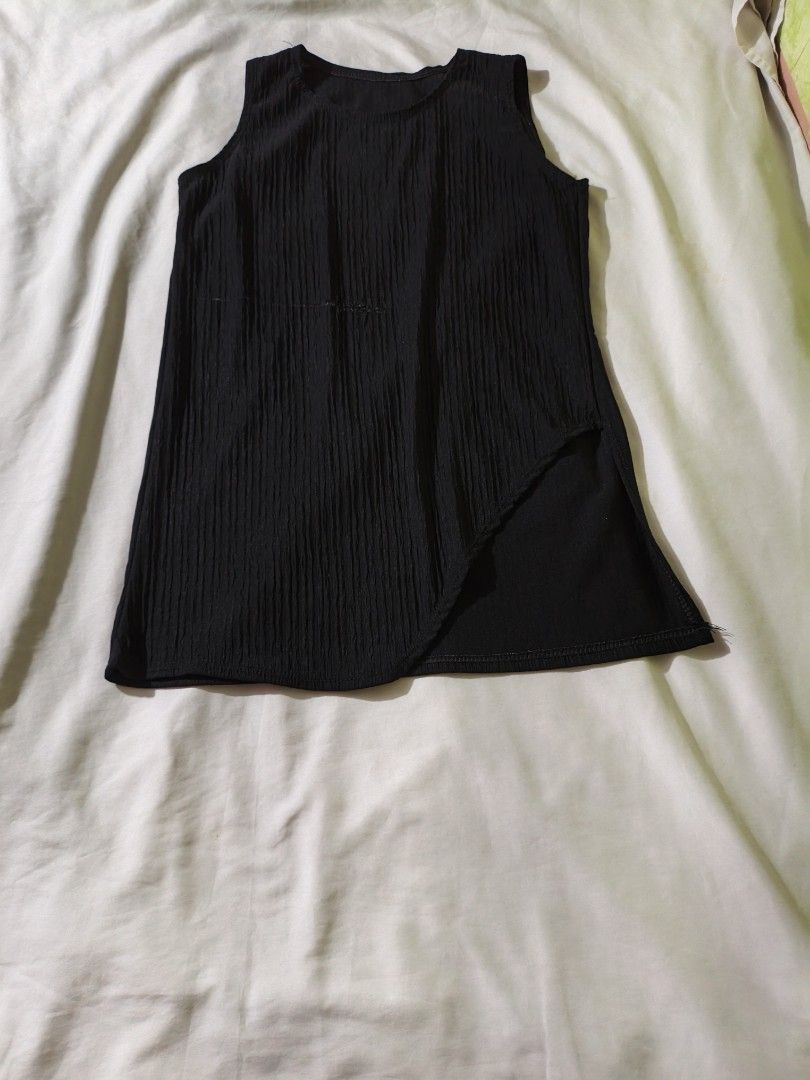 Black Textured Sleeveless Top with Asymmetrical Hem (Category: Sleeveless) located in Manila. Submitted by ms_pamaqued (Listing ID 1464355096, Image 1). Description: - Black sleeveless top - Textured ribbed fabric - Unique asymmetrical hemline - Side slit detail - Versatile for casual or dressy looks - Great for layering.