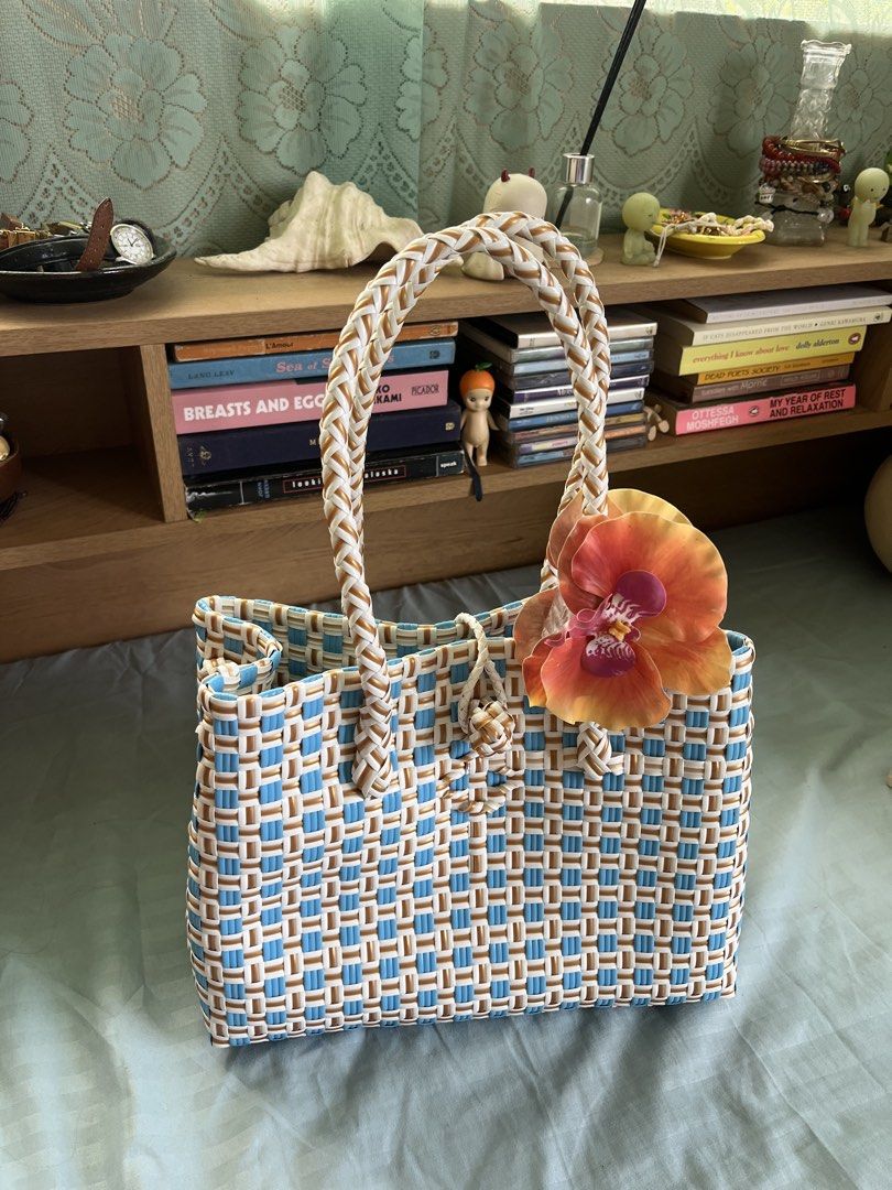 Blue and Tan Woven Rattan Bag (Category: Tote Bags) located in Iloilo. Submitted by warmspicyyy (Listing ID 1464371821, Image 1). Description: -Rattan bag bought from 🍊shop for 700 pesos - used once from my elyu trip - Braided handles - very spacious inside, can fit all of your beach essentials - Ideal for beach days or everyday use.