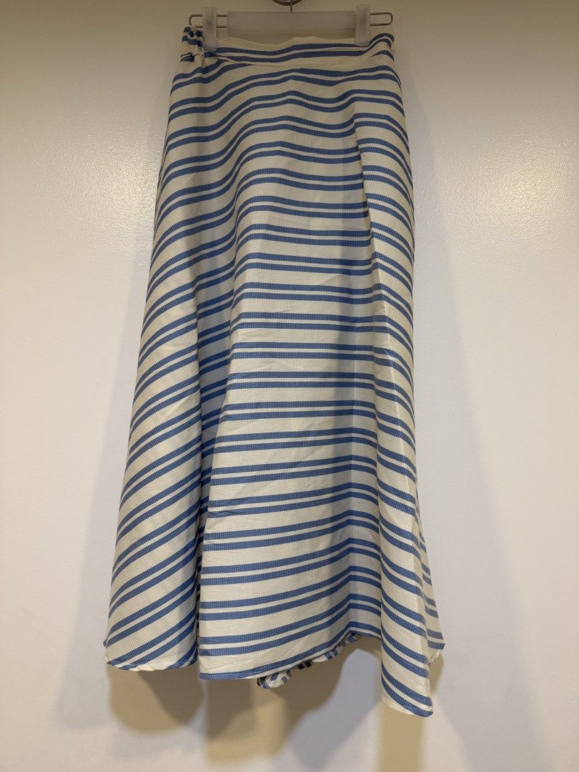 Blue and White Striped Maxi Skirt (Category: Skirts) located in Mandaluyong City. Submitted by closet.me (Listing ID 1464479719, Image 1). Description: - Flowy maxi skirt - Blue and white stripe pattern - High-waisted design - Tie detail at the waist - Lightweight and breathable fabric - Ideal for casual outings or beach days - Versatile wardrobe addition.