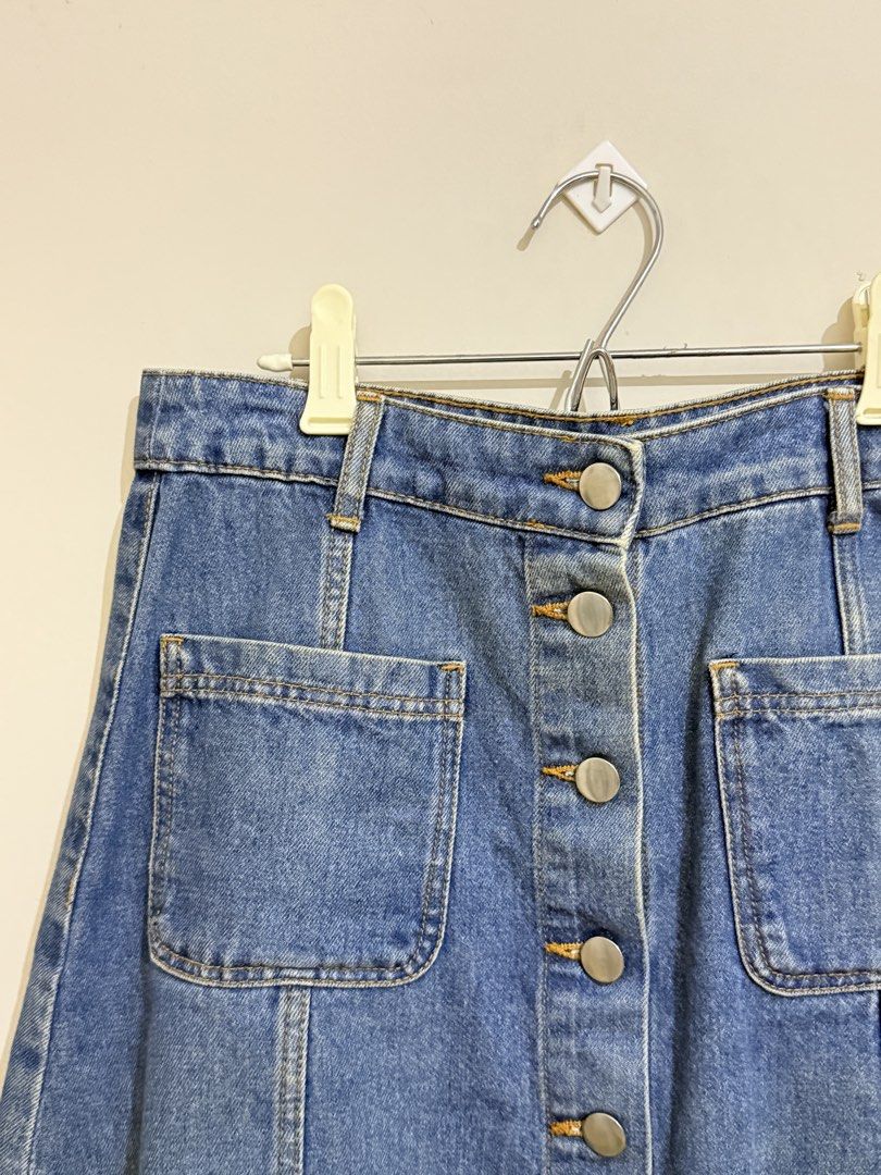 Blue Button-Front Denim Skirt (Category: Skirts) located in San Pedro. Submitted by itsminaxvii (Listing ID 1464476687, Image 2). Description: - Classic blue denim skirt - A-line cut - Button-front closure - Two front pockets with flap details.