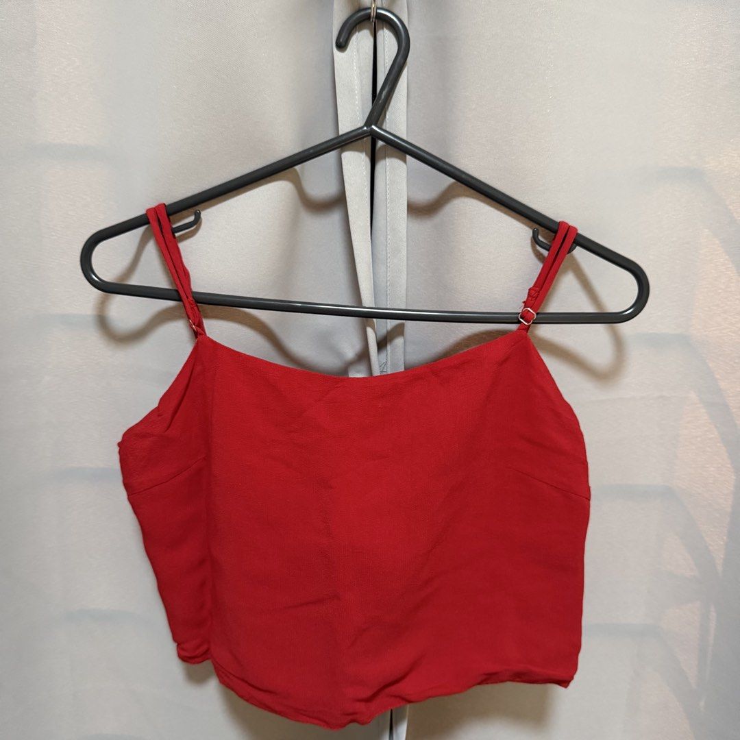 Brandy Melville Red Tie Back Crop Top (Category: Sleeveless) located in Makati City. Submitted by heyitsg_ (Listing ID 1464418405, Image 1). Description: - Cute red crop top from Brandy Melville - Features adjustable spaghetti straps - Tie-back detail for a customizable fit - Textured fabric for added appeal - Versatile for casual wear or dressing up - Easily pairs with jeans or skirts.
