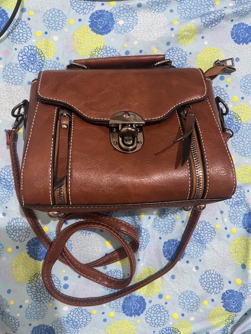 Brown Faux Leather Handbag with Silver Hardware (Category: Shoulder Bags) located in Caloocan City. Submitted by sblacena (Listing ID 1464422076, Image 1). Description: RFS di nagagamit. Once lang nagamit. Can meet up kai mall/ zabarte town center area.