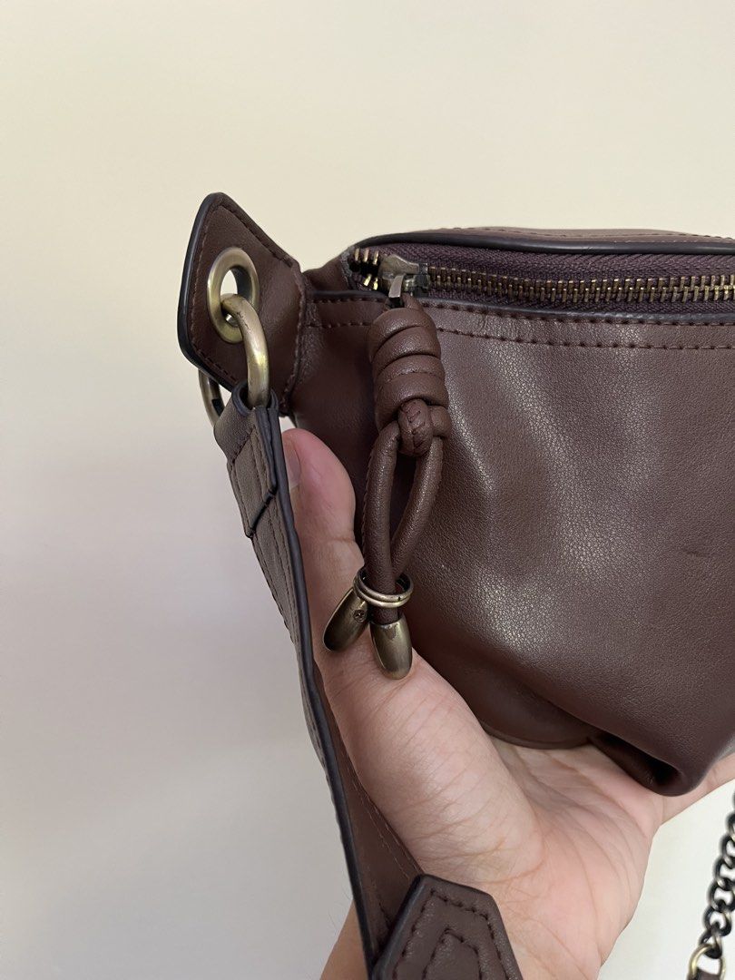 Coffee Brown Leather Bum Bag with Chain Strap (Category: Cross-body Bags) located in Sariaya. Submitted by retro.stuff (Listing ID 1464428114, Image 2). Description: Stylish brown leather bum bag with zip closure. Features card slots inside. Comes with both leather and chain straps for versatile wear as a crossbody or shoulder bag. Minimal scuff but still in pristine condition. .
