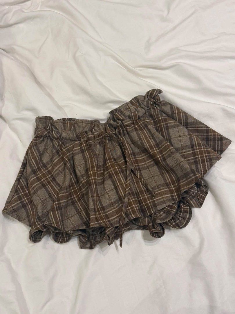 Brown Plaid Ruffle Skirt with Drawstring (Category: Skirts) located in Pasay City. Submitted by cia.clln (Listing ID 1464454738, Image 1). Description: Cute brown plaid skirt with ruffled hem and drawstring waist. Nice fabric texture. Versatile for casual or dressed-up looks..