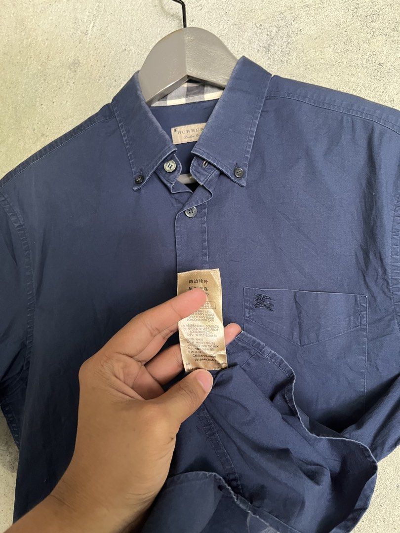 Burberry Blue Short Sleeve Polo (Category: Luxury Apparel) located in Adams. Submitted by princess.maggie (Listing ID 1464396314, Image 3). Description: - in good condition - small on tag - 19.5 x 28 (29Back) - no issue - complete tags .