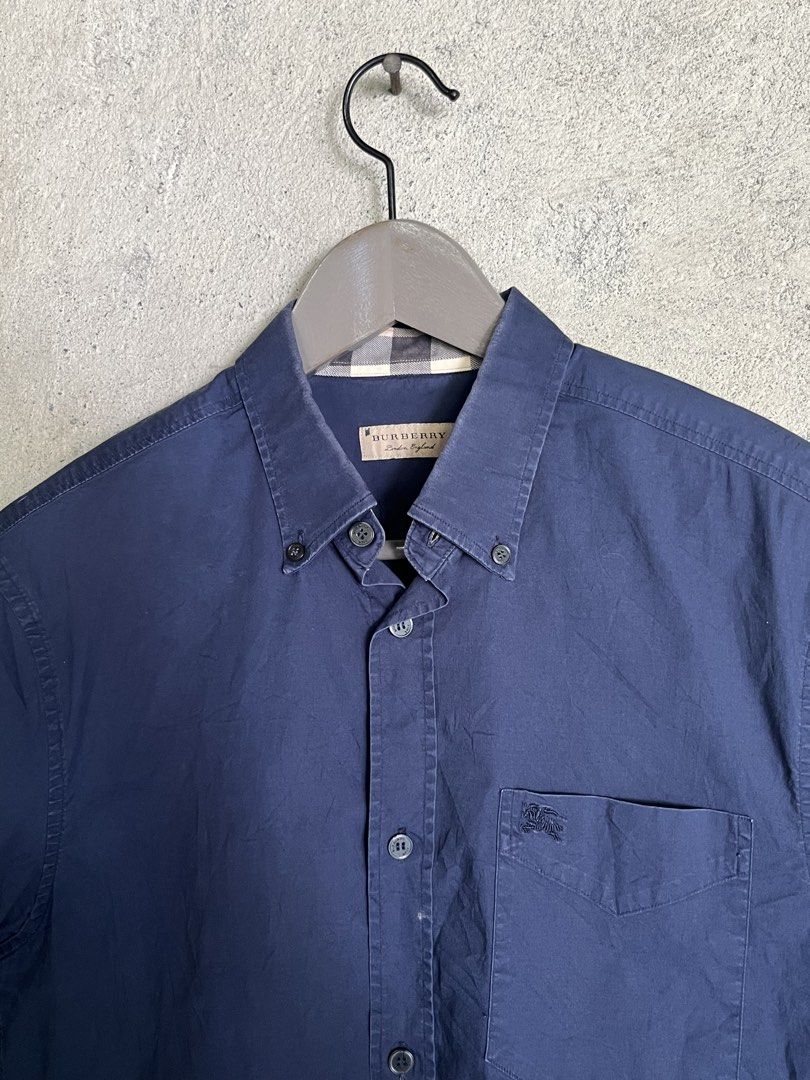 Burberry Blue Short Sleeve Polo (Category: Luxury Apparel) located in Adams. Submitted by princess.maggie (Listing ID 1464396314, Image 2). Description: - in good condition - small on tag - 19.5 x 28 (29Back) - no issue - complete tags .