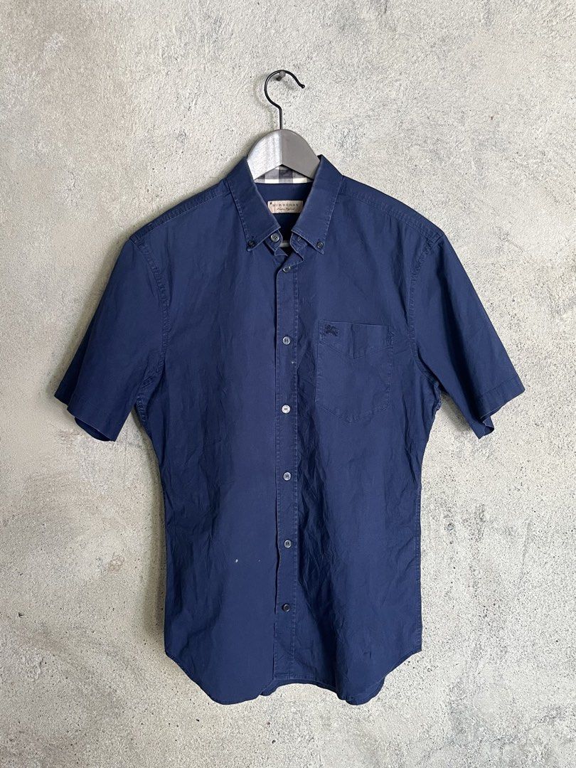 Burberry Blue Short Sleeve Polo (Category: Luxury Apparel) located in Adams. Submitted by princess.maggie (Listing ID 1464396314, Image 1). Description: - in good condition - small on tag - 19.5 x 28 (29Back) - no issue - complete tags .