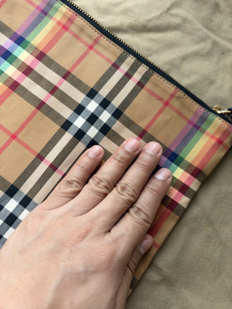 Burberry Rainbow Check Zip Pouch (Category: Luxury Bags & Wallets) located in Mandaluyong City. Submitted by material_boi (Listing ID 1464411944, Image 2). Description: Made in Italy. Maganda siya super soft and smooth. Main material is 100% cotton and then leather trims. Brass-gold yung zipper. This is flat and not structured. Approx 12 inches wide and 9 inches long. No issues. May random dirt lang di maiiwasan lasi cotton yan. Code is: CFPCXP12
