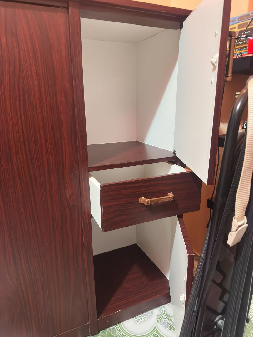 Cabinet (Category: Shelves, Cabinets & Racks) located in Quezon City. Submitted by milktea26 (Listing ID 1464369344, Image 3). Description: Used wardrobe made from wood pero sticker lang yung nakikita nyong dark brown. Good for me naman yung sticker lang since hindi ko na sya need i-varnish at hindi din kumukupas yung color. May susi din sa malaking lalagyanan. RFS: Bought a 2x larger one.