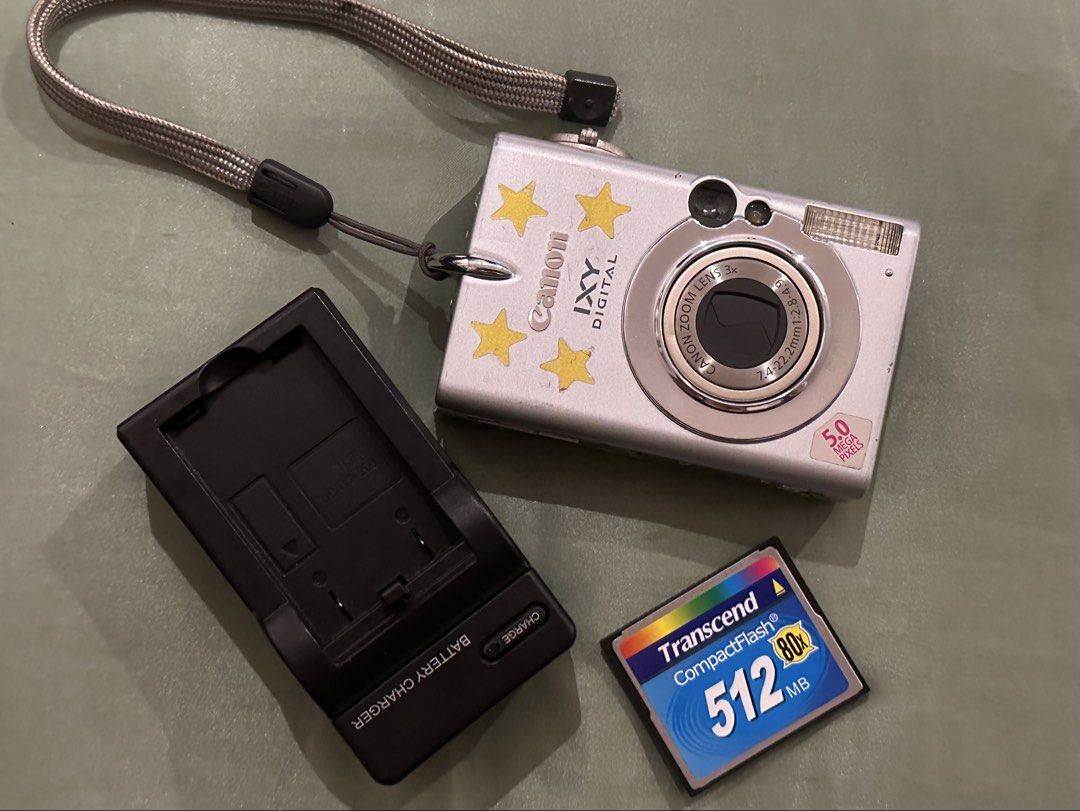 Canon IXY DIGITAL 5.0 Megapixels Camera with Accessories (Category: Cameras) located in Quezon City. Submitted by stroberi444 (Listing ID 1464408750, Image 2). Description: - Silver Canon IXY DIGITAL camera - 5.0 Megapixels - 3x Optical Zoom - Includes: Battery charger, 512MB Transcend CompactFlash card, original software CDs - Original box included - Ideal for casual photography.