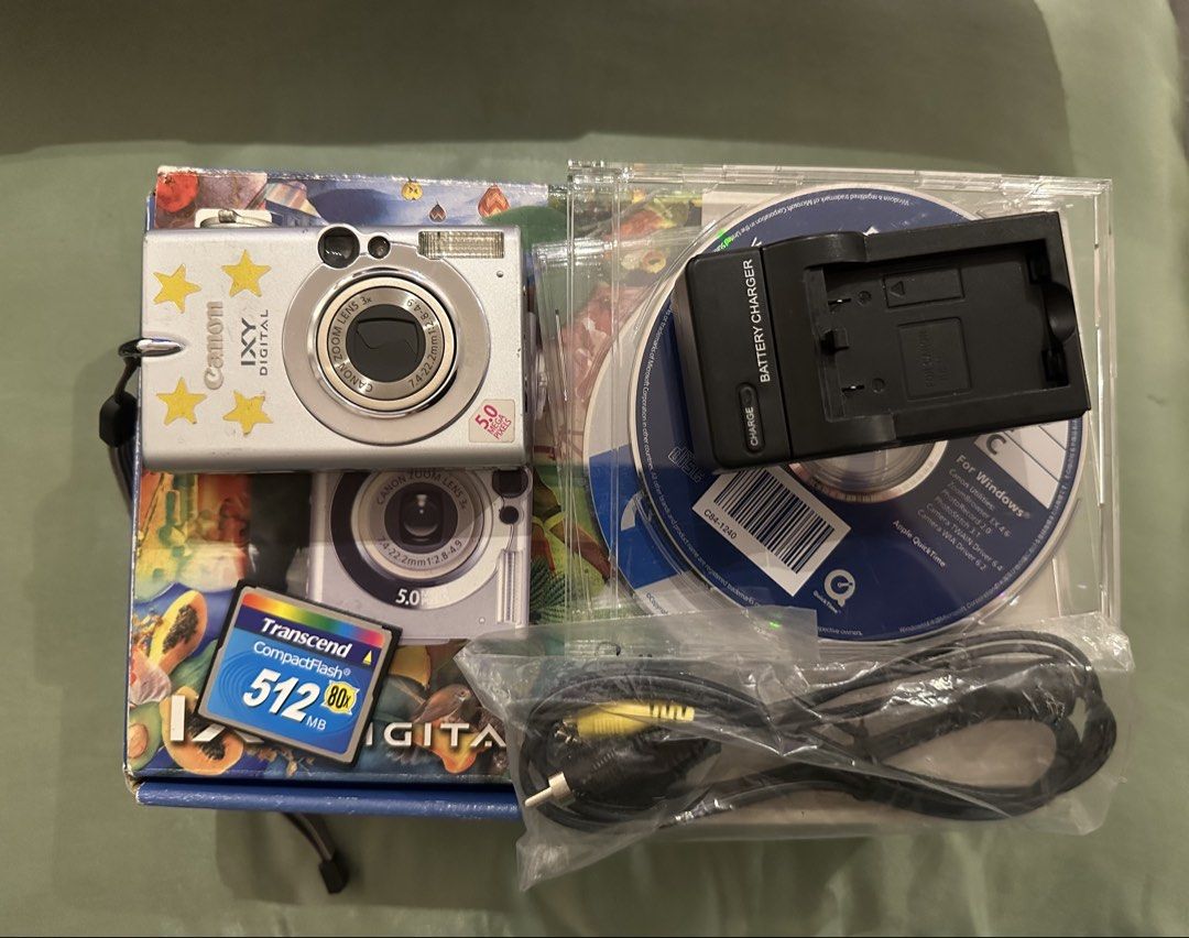 Canon IXY DIGITAL 5.0 Megapixels Camera with Accessories (Category: Cameras) located in Quezon City. Submitted by stroberi444 (Listing ID 1464408750, Image 3). Description: - Silver Canon IXY DIGITAL camera - 5.0 Megapixels - 3x Optical Zoom - Includes: Battery charger, 512MB Transcend CompactFlash card, original software CDs - Original box included - Ideal for casual photography.