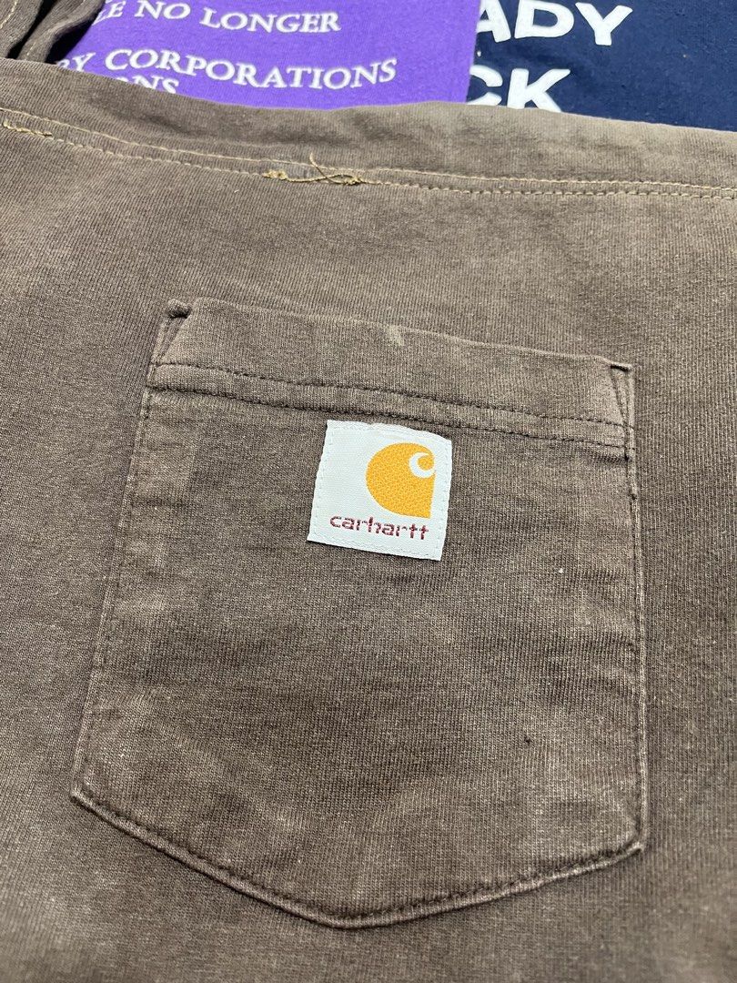 Carhartt Brown Canvas Tote Bag (Category: Tote Bags) located in Baao. Submitted by plainclothesdept (Listing ID 1464528230, Image 2). Description: Reworked Carha\rtt Sling Bag width - 12 in. height - 15 in. from authentic carhartt longsleeve, w/ zipper, dot stain, discoloration - Brand: Carhartt - Type: Canvas Tote Bag - Color: Brown - Features: Front pocket with Carhartt logo patch - Material: Durable canvas with a slightly washed look - Conditi