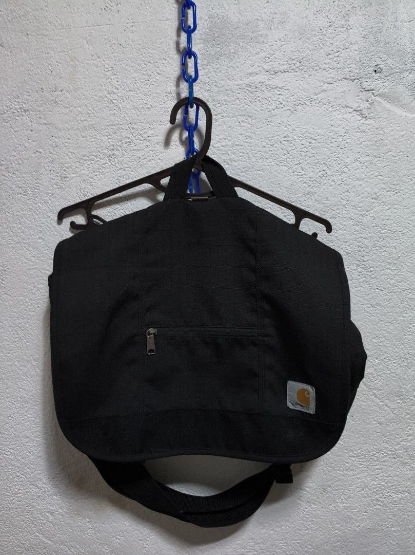 Carhartt D89 Messenger Bag Black (Category: Sling Bags) located in Malilipot. Submitted by aronbigorn96320 (Listing ID 1464462904, Image 1). Description: - Durable black Carhartt messenger bag - Front zip pocket for quick access - Spacious main compartment for essentials - Adjustable strap for comfortable carrying - Ideal for everyday use - Water resistant - 19"x 14"x 5" - Minimal scratch and Sign of usage - Money Back Guaranteed if peke.