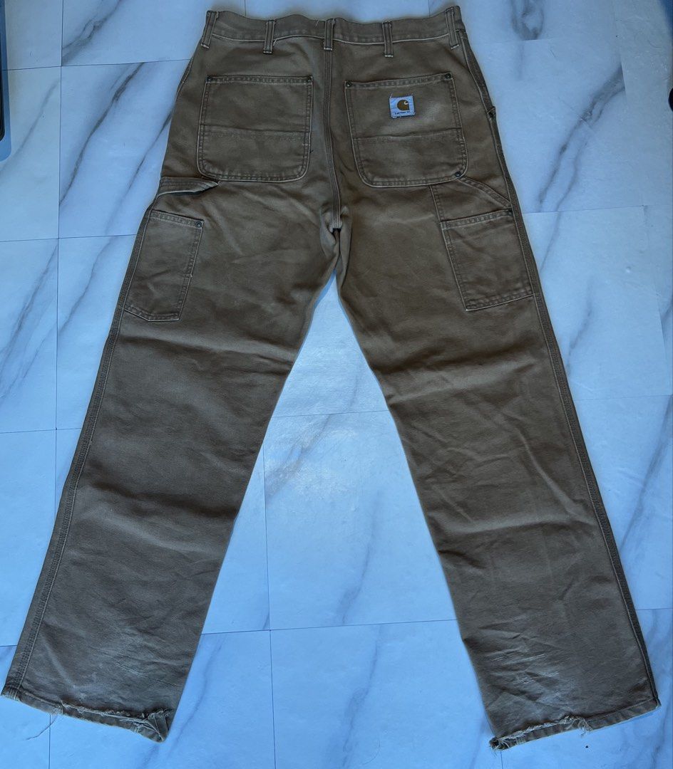 Carhartt Work Pants Tan Carpenter Double Knee (Category: Jeans) located in Cavite. Submitted by christianzuuu (Listing ID 1464497089, Image 1). Description: - Issues on bottom part and faded tag - Carhartt work pants - Color: Tan - Style: Carpenter - Features: Double knees - Condition: Some wear on hems, a few small marks on front - Classic, durable workwear - Perfect for your next project.