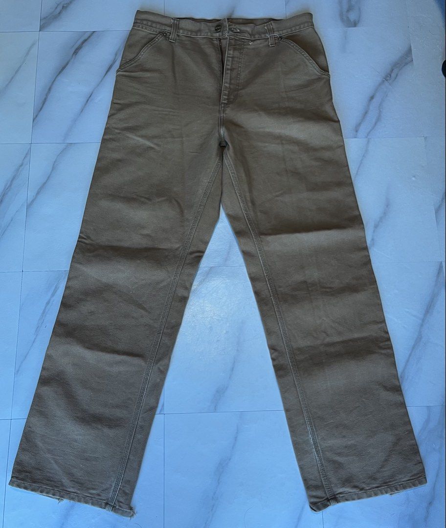 Carhartt Work Pants Tan Carpenter Double Knee (Category: Jeans) located in Cavite. Submitted by christianzuuu (Listing ID 1464497089, Image 2). Description: - Issues on bottom part and faded tag - Carhartt work pants - Color: Tan - Style: Carpenter - Features: Double knees - Condition: Some wear on hems, a few small marks on front - Classic, durable workwear - Perfect for your next project.