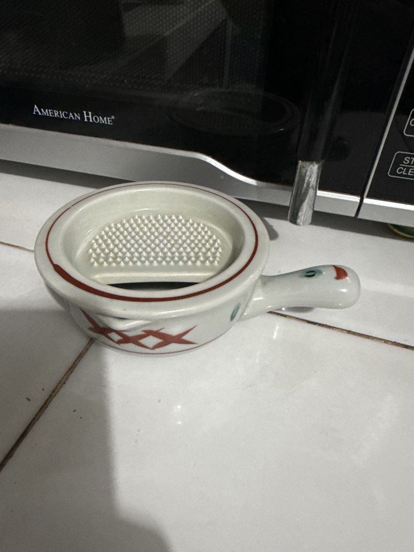 Ceramic Grater Bowl with Handle and Lid (Category: Cookware & Accessories) located in Tuguegarao City. Submitted by purrposeph (Listing ID 1464457079, Image 1). Description: - Cute ceramic bowl with built-in grater - Features a handle for easy grip - Includes a lid for convenience - Ideal for grating garlic, ginger, or cheese - Stylish white design with red accents and a charming duck-like handle - A practical addition to your kitchen prep tools.