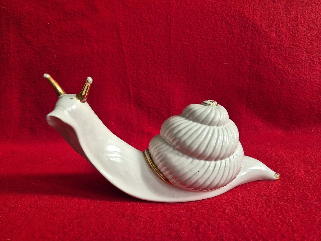 Ceramic Snail Decor, 10" (Category: Other Home Decor) located in Makati City. Submitted by maydeleo1 (Listing ID 1464385878, Image 1). Description: Vintage White Ceramic Snail Decor with Gold Accents Add a touch of elegant charm to your space with this 10-inch ceramic snail figurine. It features a glossy white finish beautifully accented with gold details on its shell rim and antennae. A perfect statement piece for bookshelves, coffee tables, or 