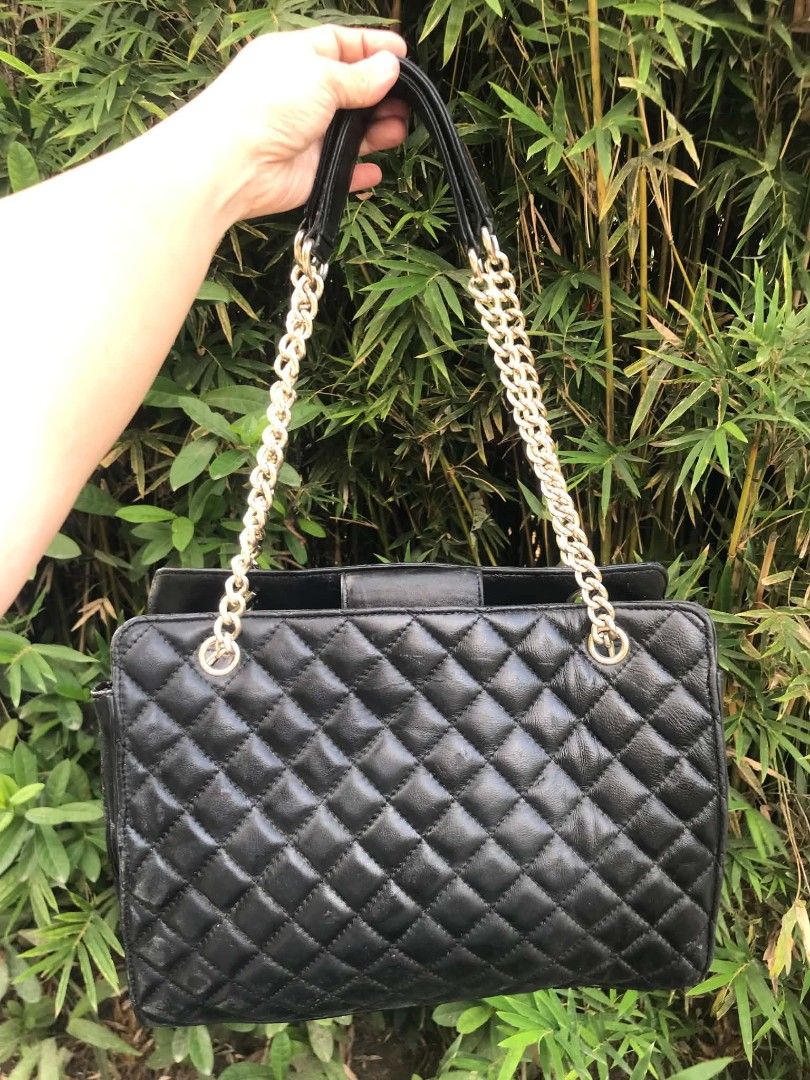 Chanel Black Quilted Leather Chain Shoulder Bag (Category: Tote Bags) located in Midsayap. Submitted by purse_gedo (Listing ID 1462615625, Image 2). Description: - Black Quilted Chanel Bag - Iconic Gold Chain Straps - Signature CC Logo on Front - Interior Chanel Branding - Secure Zipper Closure - Timeless Piece for Any Collection - Versatile for Everyday or Special Occasions.