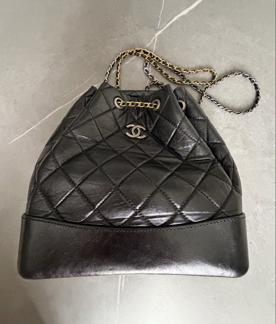 Chanel Black Quilted Leather Drawstring Backpack (Category: Backpacks) located in Quezon City. Submitted by oliviapalermo (Listing ID 1464398703, Image 1). Description: - Chanel drawstring bag/ can be used as sling bag - Black quilted leather with a soft, crinkled finish - Mix of gold and silver hardware - Secure drawstring closure with chain details - Classic and versatile for everyday or special events.