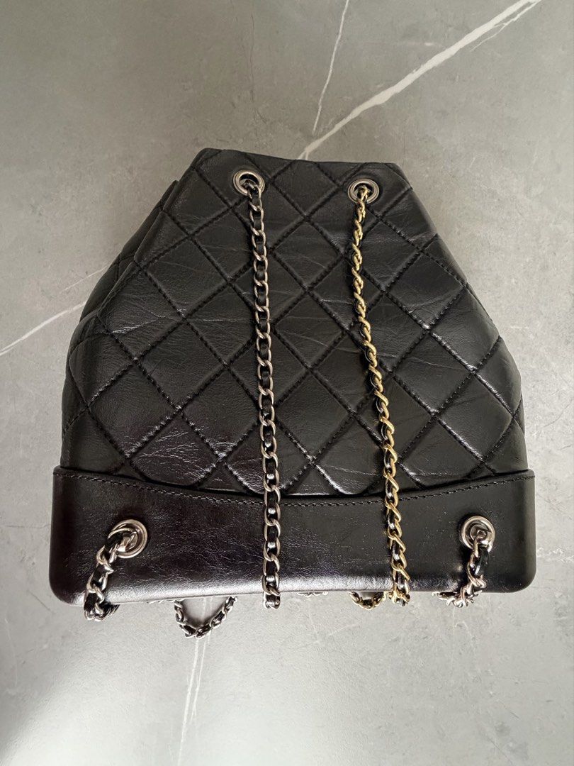 Chanel Black Quilted Leather Drawstring Backpack (Category: Backpacks) located in Quezon City. Submitted by oliviapalermo (Listing ID 1464398703, Image 3). Description: - Chanel drawstring bag/ can be used as sling bag - Black quilted leather with a soft, crinkled finish - Mix of gold and silver hardware - Secure drawstring closure with chain details - Classic and versatile for everyday or special events.