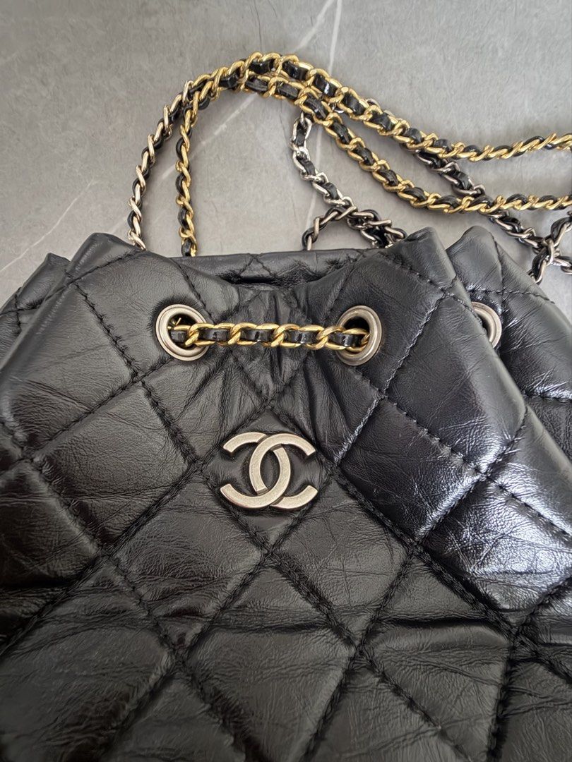 Chanel Black Quilted Leather Drawstring Backpack (Category: Backpacks) located in Quezon City. Submitted by oliviapalermo (Listing ID 1464398703, Image 2). Description: - Chanel drawstring bag/ can be used as sling bag - Black quilted leather with a soft, crinkled finish - Mix of gold and silver hardware - Secure drawstring closure with chain details - Classic and versatile for everyday or special events.