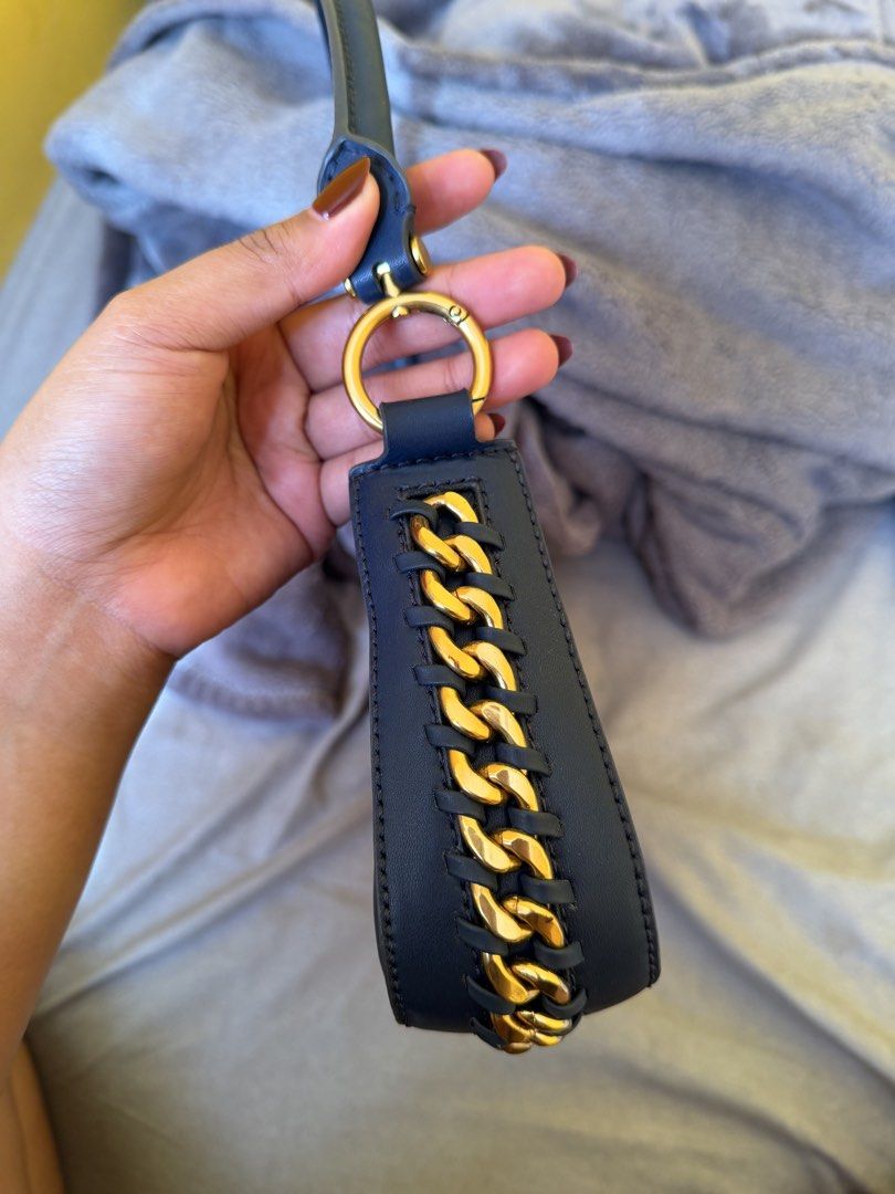 Charles & Keith Bag (Shoulder/Crossbody) (Category: Shoulder Bags) located in Bacoor. Submitted by sonnybbs (Listing ID 1464359699, Image 3). Description: - Navy blue shoulder bag by Charles & Keith - Elegant curved silhouette - Gold-tone hardware and decorative chain strap detail - Secure zipper closure - Interior zippered pocket and slip pocket - Versatile for everyday wear or evening events - Authentic (used once/twice only) forgot the name of
