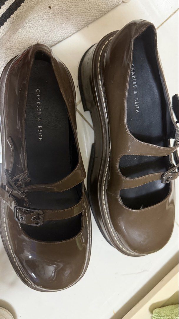 Charles and keith shoes - slightly used (Category: Flats & Sandals) located in Pasig City. Submitted by tuttobox (Listing ID 1464546896, Image 3). Description: Step out in style with these beautiful brown Mary Jane flats featuring a glossy finish, chic double straps, and adjustable buckle closures. Designed with a comfortable flat sole, these timeless shoes are perfect for everyday wear, casual outings, or dressing up your favorite outfits. ✨ Fea