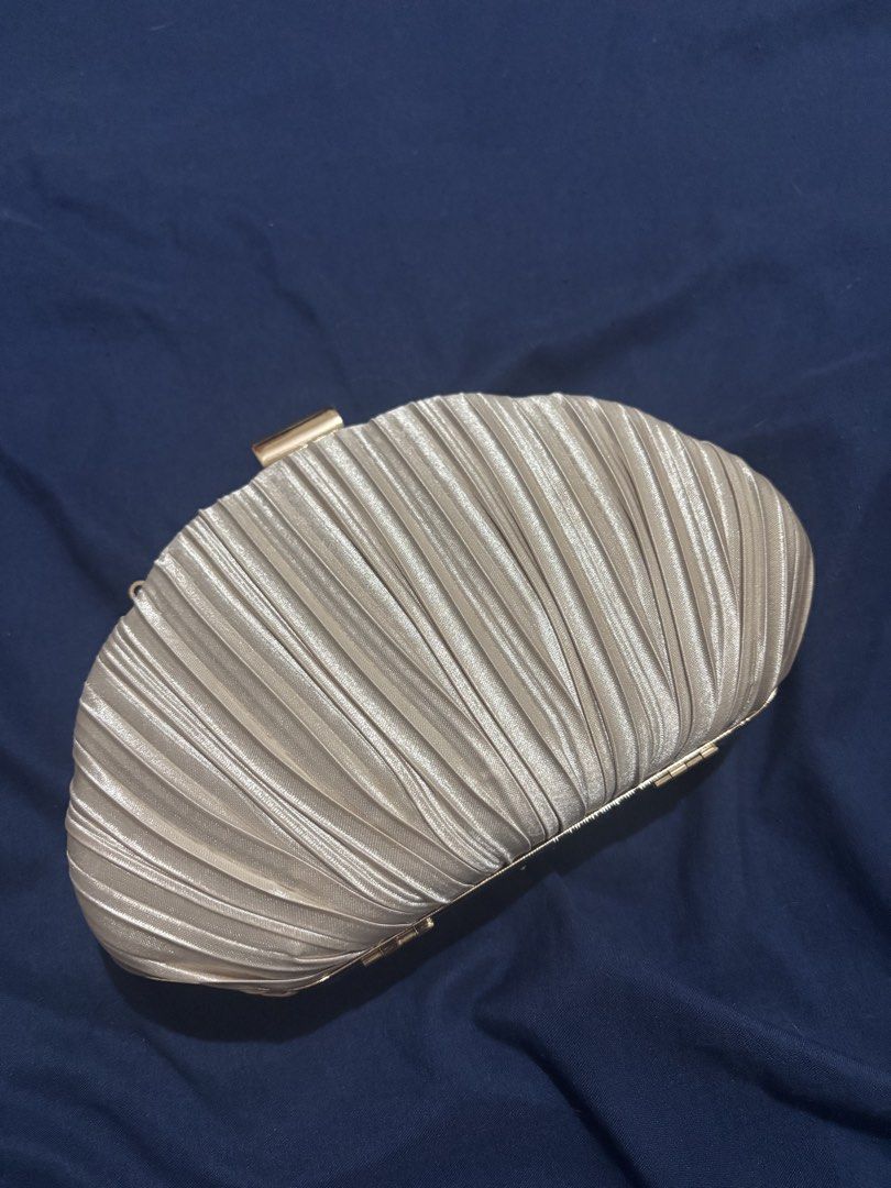ChicCharms Pleated Clutch Evening Bag with Chain (Category: Clutches) located in Manila. Submitted by jobithings (Listing ID 1464524496, Image 3). Description: - Stunning gold pleated clutch purse - Secure clasp closure for safety - Convenient inner zipped pocket - Detachable gold chain for versatile styling - Ideal for parties, weddings, and special events - Fits your phone, keys, and lipstick.