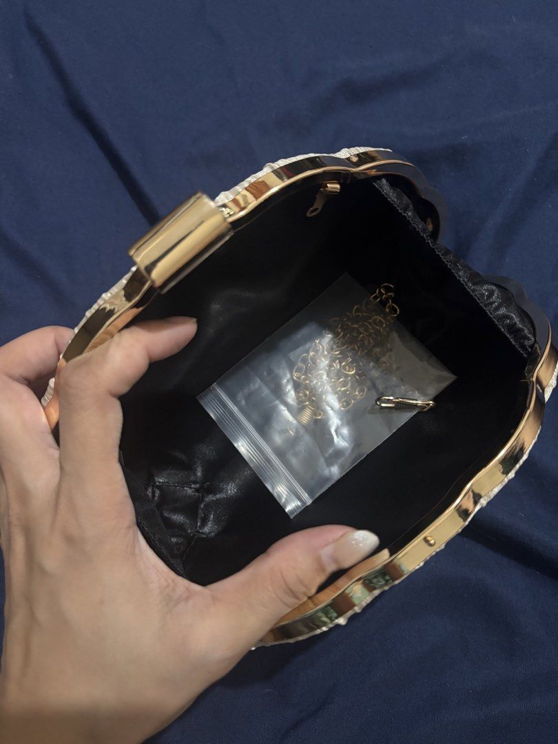 ChicCharms Pleated Clutch Evening Bag with Chain (Category: Clutches) located in Manila. Submitted by jobithings (Listing ID 1464524496, Image 2). Description: - Stunning gold pleated clutch purse - Secure clasp closure for safety - Convenient inner zipped pocket - Detachable gold chain for versatile styling - Ideal for parties, weddings, and special events - Fits your phone, keys, and lipstick.