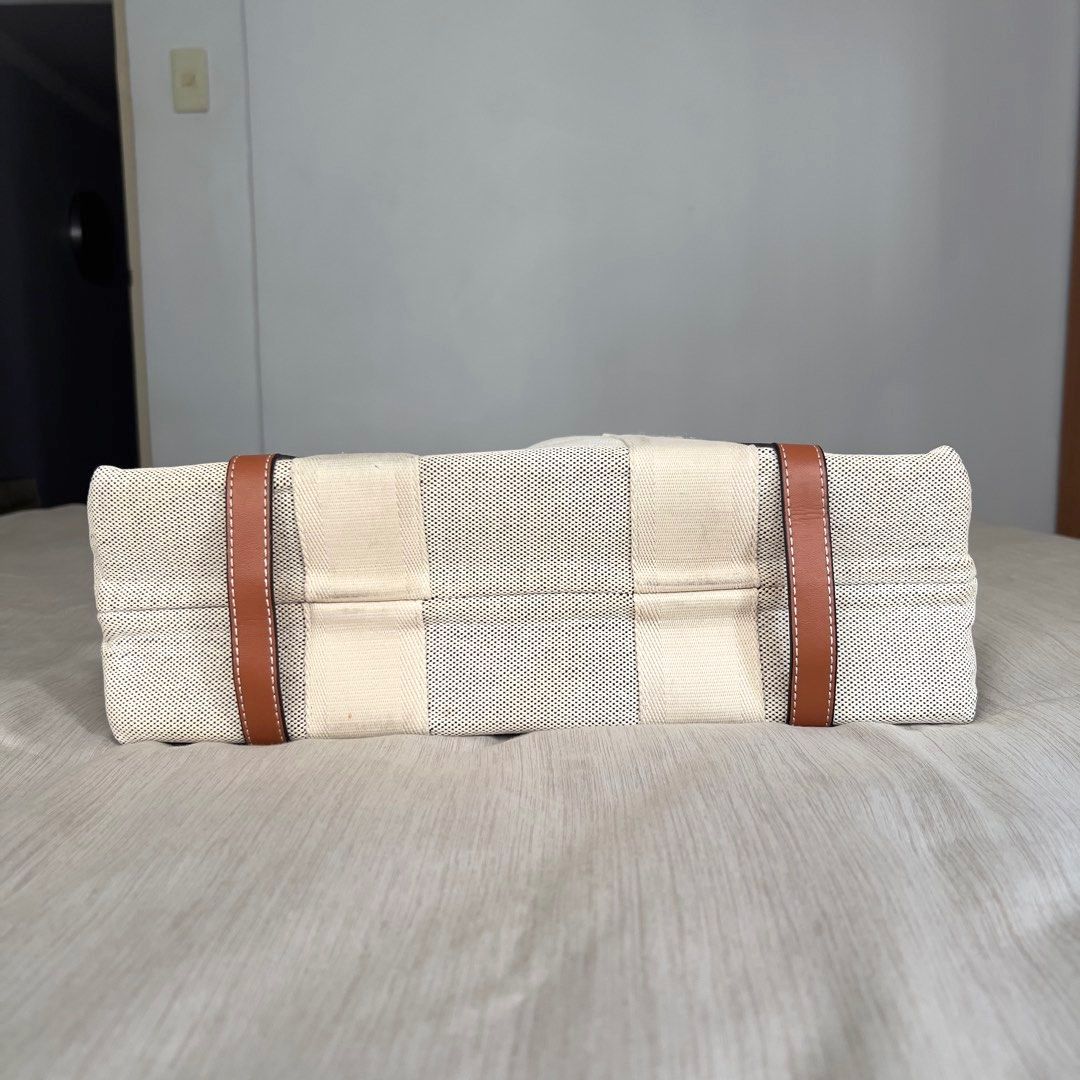 Chloe Woody Canvas Tote Bag (Category: Luxury Bags & Wallets) located in Pasig City. Submitted by jenscloset86 (Listing ID 1464436689, Image 3). Description: CHLOE Woody Canvas Tote Bag • Spacious interior with a practical flat pocket. • Used item but in a very good condition. • 9/10 rating. Good condition. Measurement in inches): Length: 14” Height: 10” Bottom: 4.5” - Chloe canvas tote bag - Iconic Chloe logo on straps - Spacious interior with c